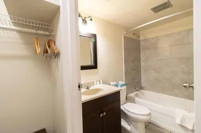 a bathroom with a sink and a toilet and a bath tub at Super 8 by Wyndham Prince George in Prince George