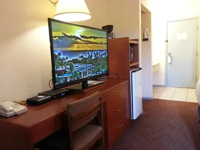 a television on a desk in a hotel room at Best Seven Inn in Claresholm