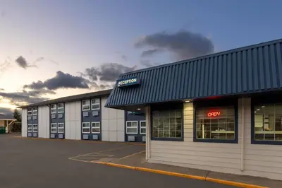 an empty parking lot in front of a building at Travelodge by Wyndham Blairmore in Blairmore