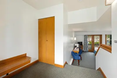 a room with a hallway with a door and a desk at Canadian Princess Lodge & Marina in Ucluelet