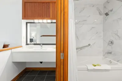 a bathroom with a tub and a sink and a bath tub at Canadian Princess Lodge & Marina in Ucluelet
