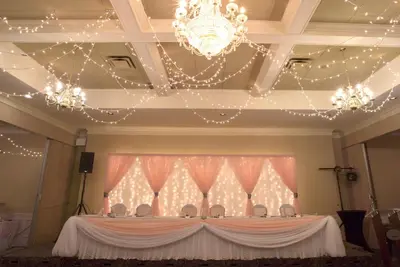 a table in a room with a chandelier at Prestige Vernon Hotel in Vernon