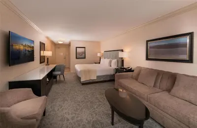 a hotel room with a bed and a couch at Prestige Lakeside Resort, WorldHotels Elite in Nelson