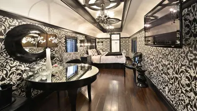 a room with a desk and a bed and a mirror at Prestige Rocky Mountain Resort Cranbrook, WorldHotels Crafted in Cranbrook