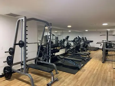 a gym with several tread machines in a room at Prestige Radium Hot Springs Resort, WorldHotels Crafted in Radium Hot Springs