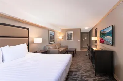 a hotel room with a bed and a couch at Prestige Radium Hot Springs Resort, WorldHotels Crafted in Radium Hot Springs