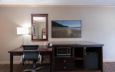 an office with a desk with a computer and a mirror at Prestige Radium Hot Springs Resort, WorldHotels Crafted in Radium Hot Springs