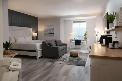 a bedroom with a bed and a chair and a desk at Prestige Harbourfront Resort, WorldHotels Luxury in Salmon Arm
