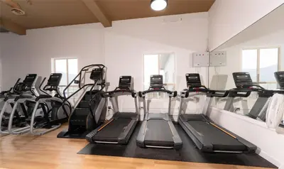 a row of treadmills in a fitness room at Prestige Harbourfront Resort, WorldHotels Luxury in Salmon Arm