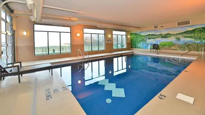 a large swimming pool in a large room withwindows at Prestige Harbourfront Resort, WorldHotels Luxury in Salmon Arm