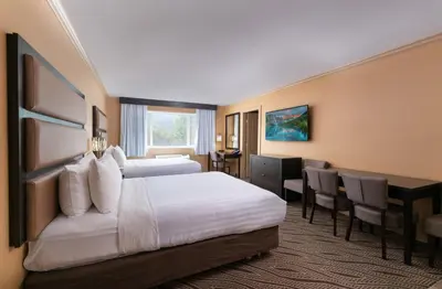 a hotel room with a bed and a desk at Prestige Golden Hotel in Golden