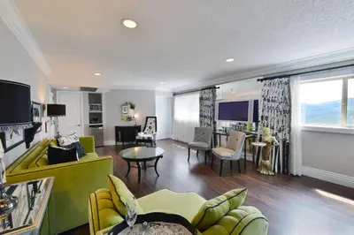 a living room with a yellow couch and a table at Prestige Mountain Resort Rossland in Rossland