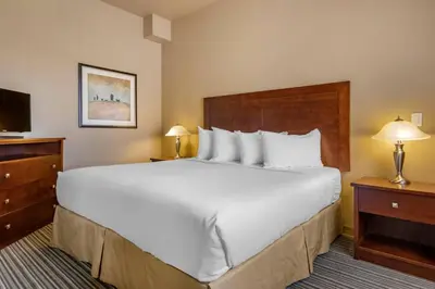 a large white bed in a hotel room at Quality Inn & Suites in Rimbey