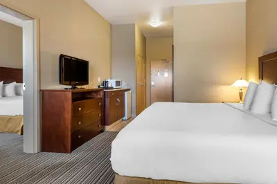 a hotel room with a bed and a flat screen tv at Quality Inn & Suites in Rimbey