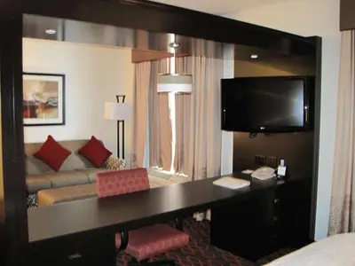 a hotel room with a desk and a couch at Hampton Inn by Hilton Fort Saskatchewan in Fort Saskatchewan