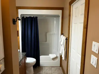 a bathroom with a white toilet and a shower at Casa Del Mila Oro in Osoyoos