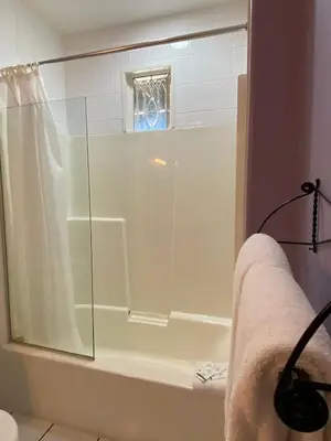 a shower with a glass door in a bathroom at The Inn at Tough City in Tofino
