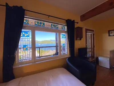 a bedroom with a bed and a window with a view at The Inn at Tough City in Tofino