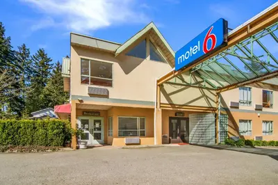a noco gas station with a sign in front of it at Motel 6 Surrey, Bc in Surrey