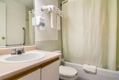a bathroom with a sink and a toilet and a shower at Motel 6 Surrey, Bc in Surrey