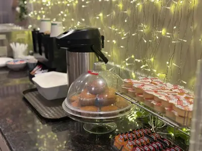 a counter with a container of cupcakes and a mixer at Lone Star Hotel in North Battleford