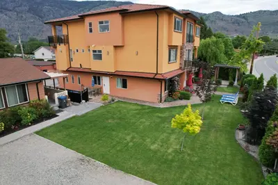 an aerial view of a house with a yard at Sahara Courtyard Inn & Suites Osoyoos in Osoyoos