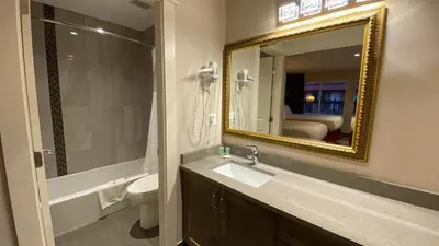 a bathroom with a sink and a mirror at Sahara Courtyard Inn & Suites Osoyoos in Osoyoos