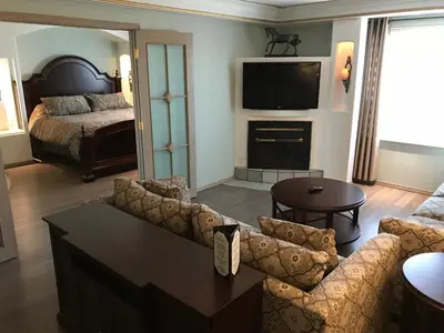 a living room with a couch and a television at Chateau Louis Hotel & Conference Centre in Edmonton