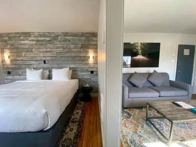 a hotel room with a bed and a couch at The Maq Hotel in Tofino