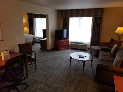 a living room with a couch and a tv at Wingate by Wyndham - Edmonton West in Edmonton