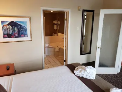 a bedroom with a bed and a bathroom at Wingate by Wyndham - Edmonton West in Edmonton