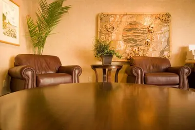 a meeting room with two chairs and a table at Coast Discovery Inn in Campbell River