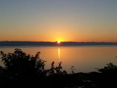 a sunset over a body of water at Edgewater Motel in Oyster Bay