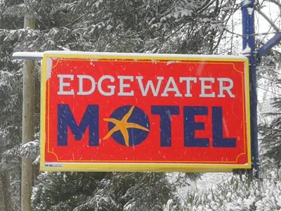 a sign for an egg water m net in the snow at Edgewater Motel in Oyster Bay