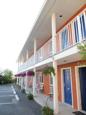 a building with blue doors and a parking lot at Cactus Tree Inn in Oliver