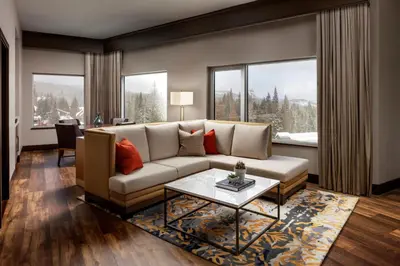 a living room with a couch and a table at The Josie Hotel, Autograph Collection in Rossland