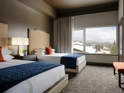 a hotel room with two beds and a large window at The Josie Hotel, Autograph Collection in Rossland