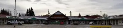 a building with a parking lot in front of it at Centre Suite Inns Motel in Bonnyville
