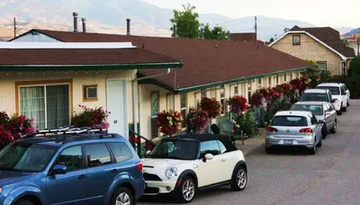 a row of cars parked on the side of a street at Boundary Motel in Osoyoos