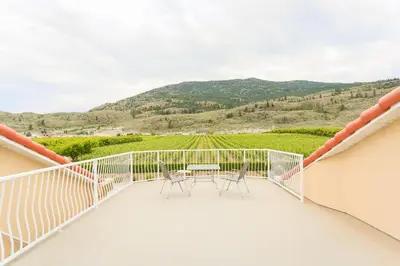 a balcony with a table and chairs and a view at Shiraz Villa in Osoyoos