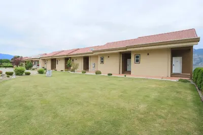 a house with a lawn in front of it at Shiraz Villa in Osoyoos