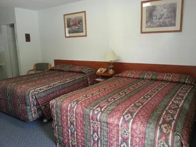 a hotel room with two beds and a telephone at Evening Star Motel in Greenwood