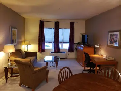 a living room with a couch and a table at Travelodge by Wyndham Spruce Grove in Spruce Grove