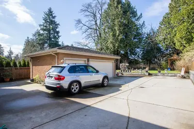 a silver car parked in front of a house at An Yang House in Burnaby