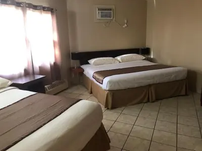 a hotel room with two beds and a window at Thriftlodge Edmonton in Edmonton