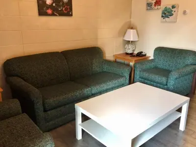 a living room with a couch and a table at Thriftlodge Edmonton in Edmonton