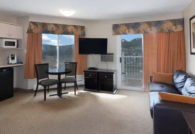 a living room with a couch and a table and chairs at BCMInns - Coleman in Coleman