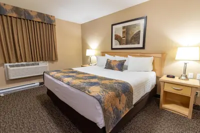 a hotel room with a large bed and a window at BCMInns - Fort McMurray - Rusty's in Fort McMurray