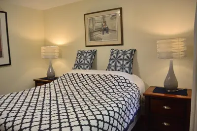 a bedroom with a bed and two lamps at Gabriola Central B&B in Gabriola