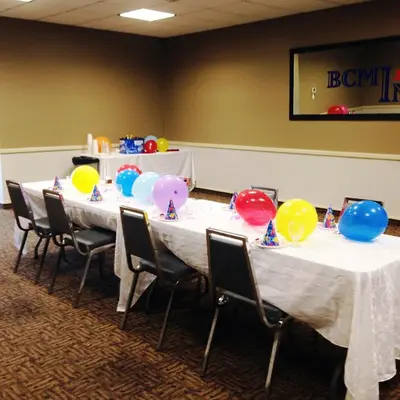 a group of tables with balloons on them at BCMInns - Lloydminster in Lloydminster